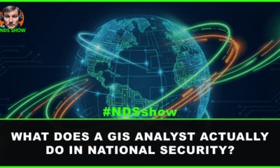 GIS analyst workstation with satellite imagery displays in a national security operations center